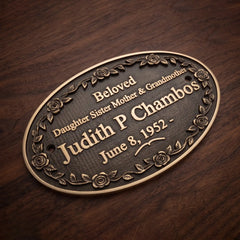 Bronze plaque with engraved text on a wooden background