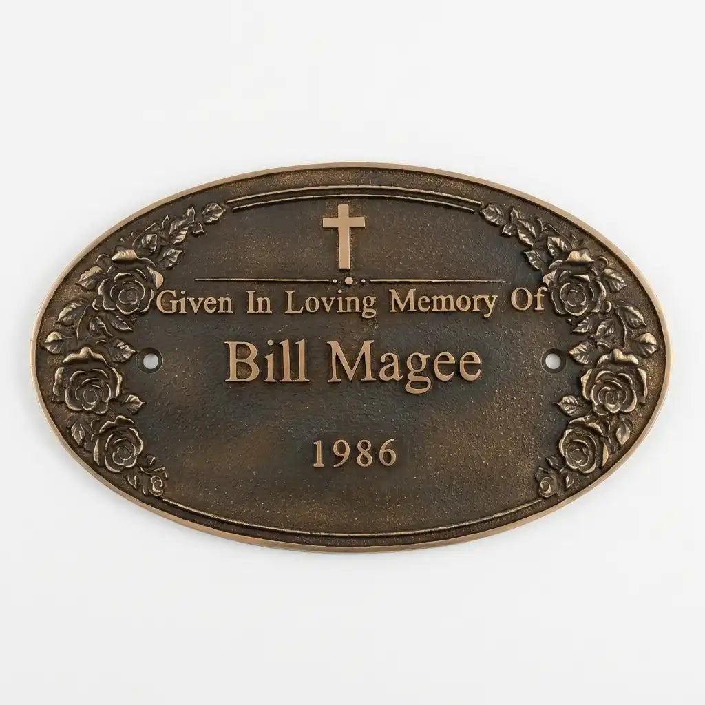 Bronze plaque with 'Given in Loving Memory of Bill Magee 1986' text on a white background