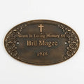 Bronze plaque with 'Given in Loving Memory of Bill Magee 1986' text on a white background
