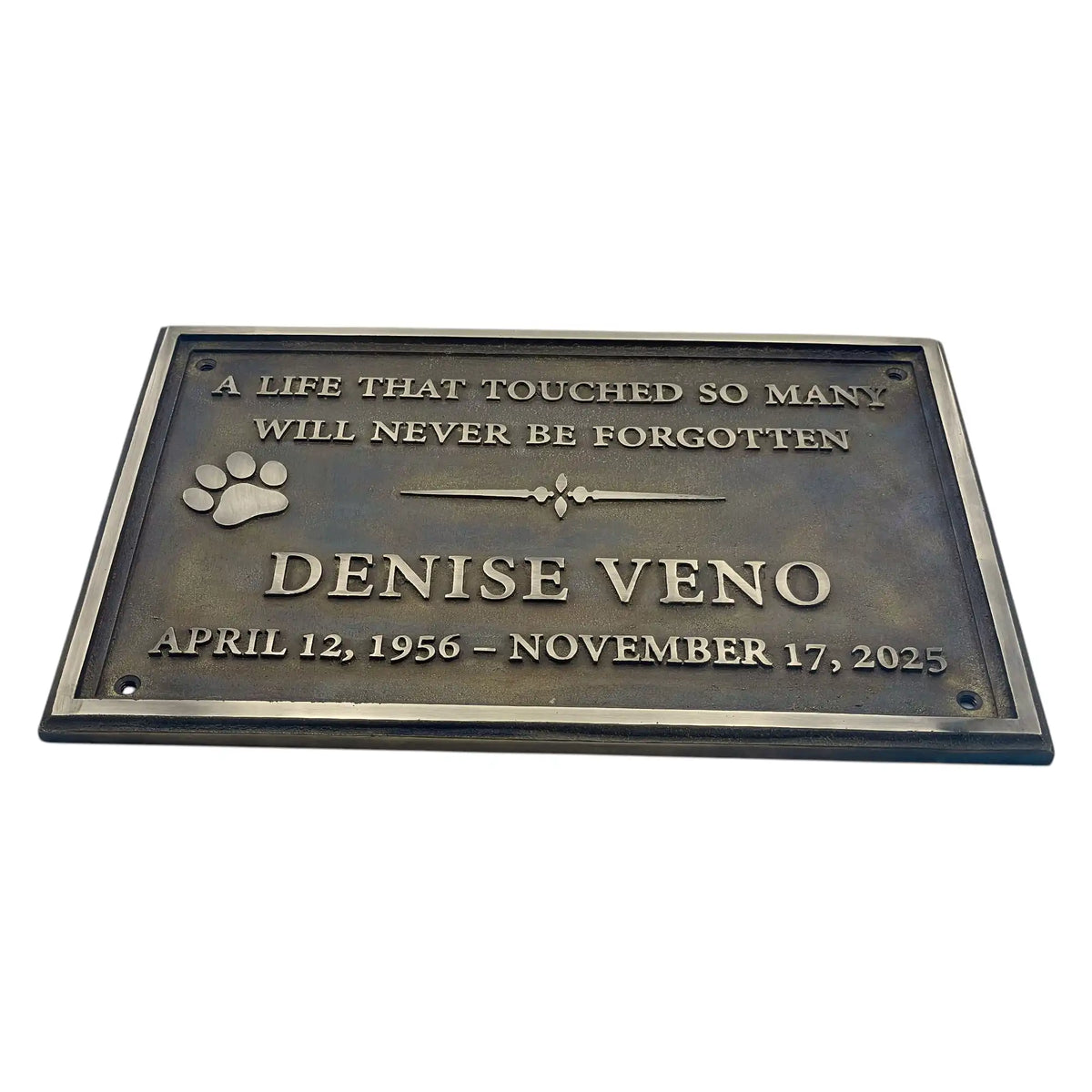 Memorial plaque for Denise Veno with text and paw print on a white background