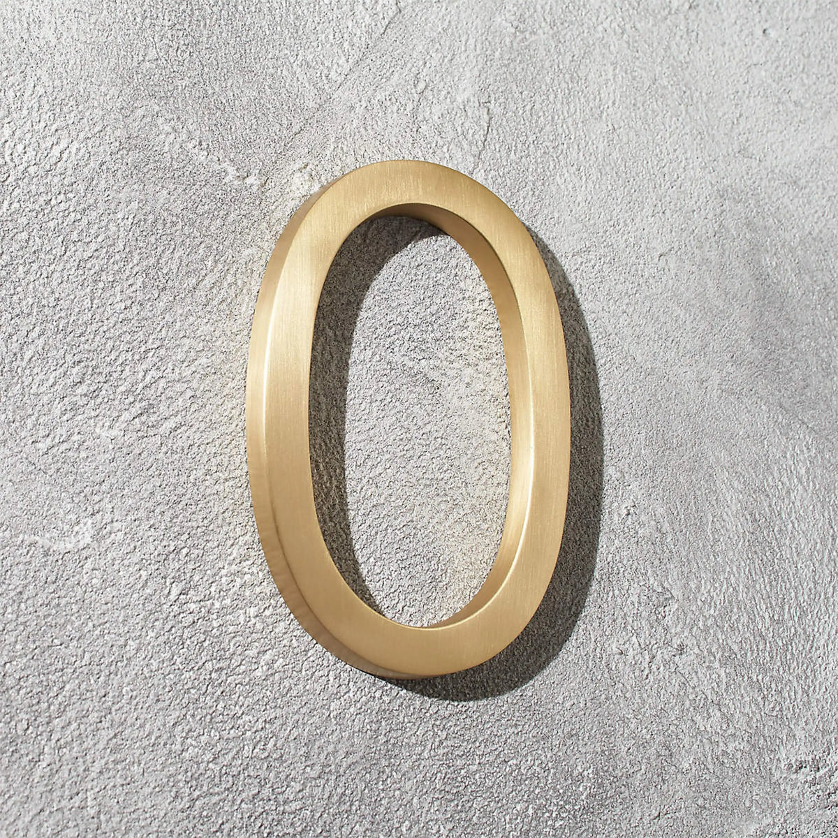 Solid brass address numbers with floating hidden stud mounting for modern home exteriors and entryways.