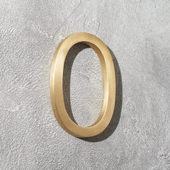 Solid brass address numbers with floating hidden stud mounting for modern home exteriors and entryways.