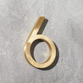Solid brass floating room and door numbers with hidden studs for offices, hotels, apartments, and interior spaces.
